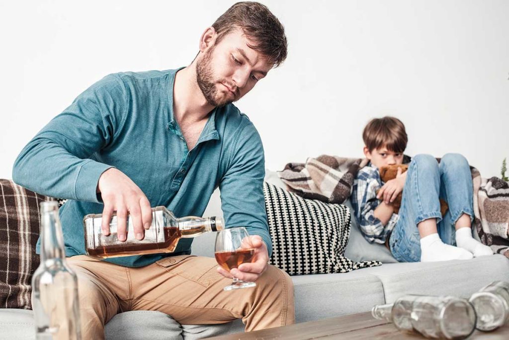 a child crying while his dad drinks not thinking about alcoholism and parenting