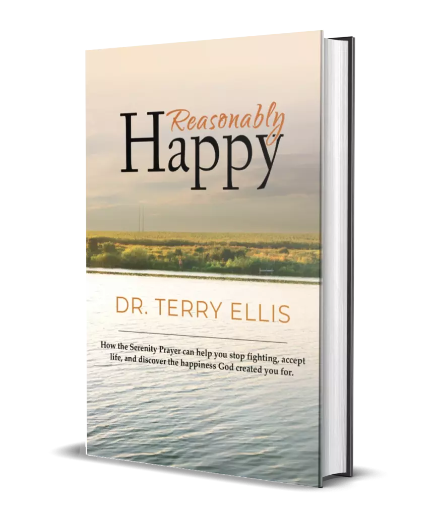 Book titled Reasonably Happy by Dr. Terry Ellis, featuring a lake and grassy landscape on the cover with a subtitle about the Serenity Prayer and finding happiness.