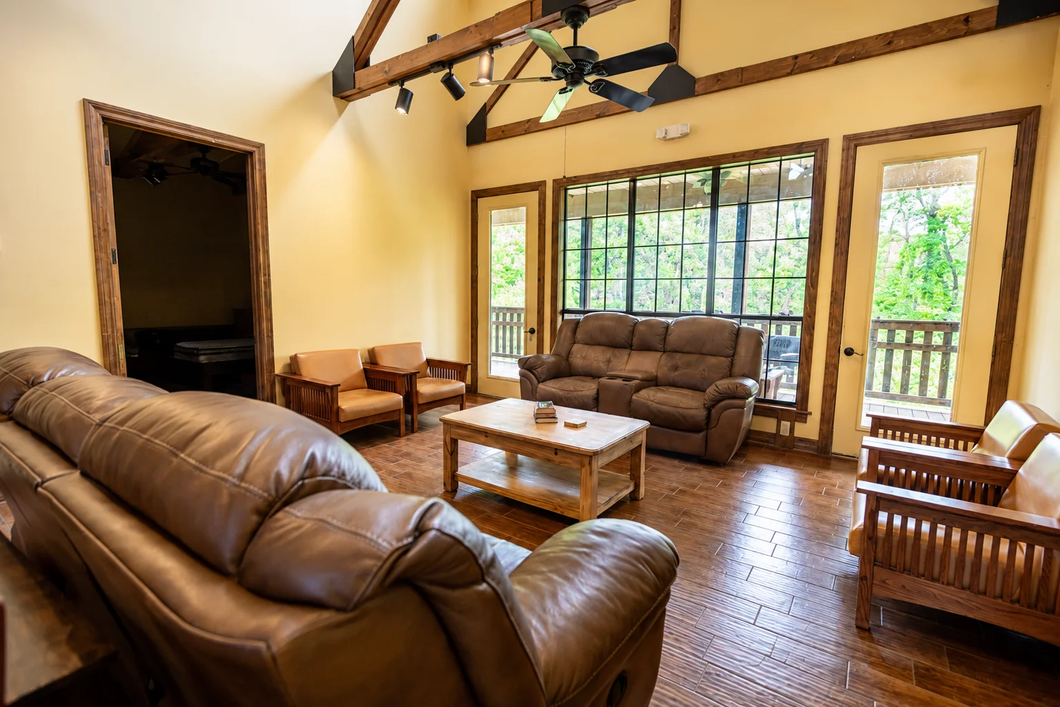 Palmetto residence sitting room with high ceiings, couches and nice furniture, and large windows