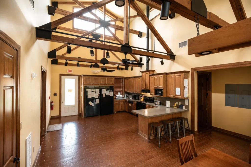 Palmetto residence kitchen and common area with high wooden rafters and lots of space
